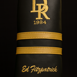Black leather case with gold logo and text on a black background