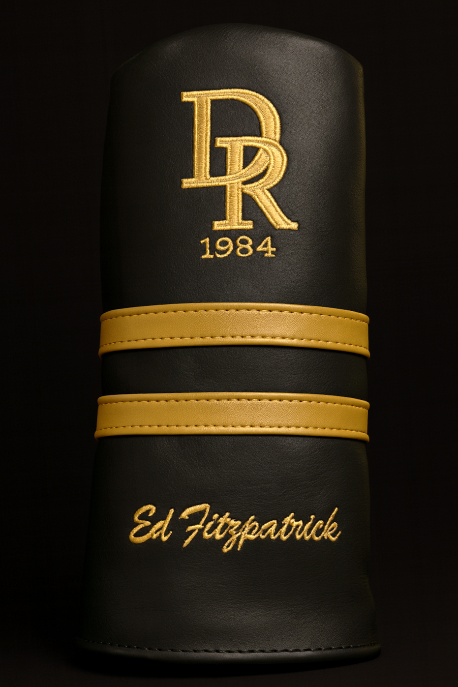 Black leather case with gold logo and text on a black background
