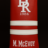 Red leather product with white branding on a black background