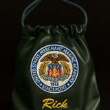 Green drawstring bag with embroidered emblem and name 'Rick' on a black background