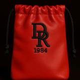 Red drawstring pouch with black logo and text on a black background