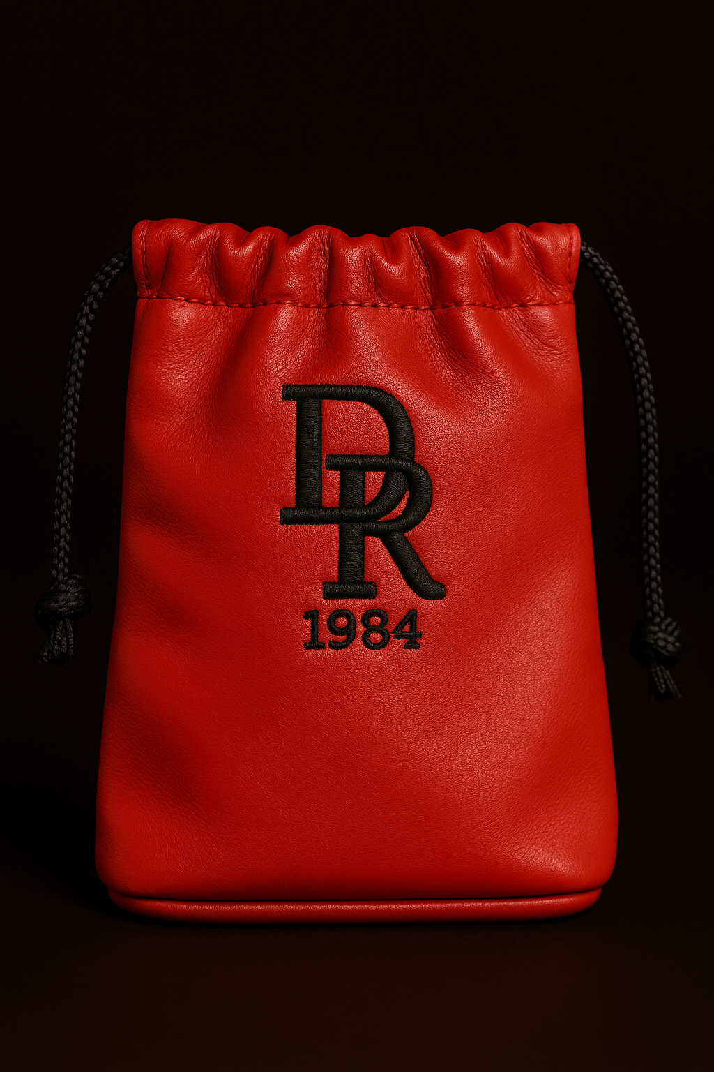 Red drawstring pouch with black logo and text on a black background