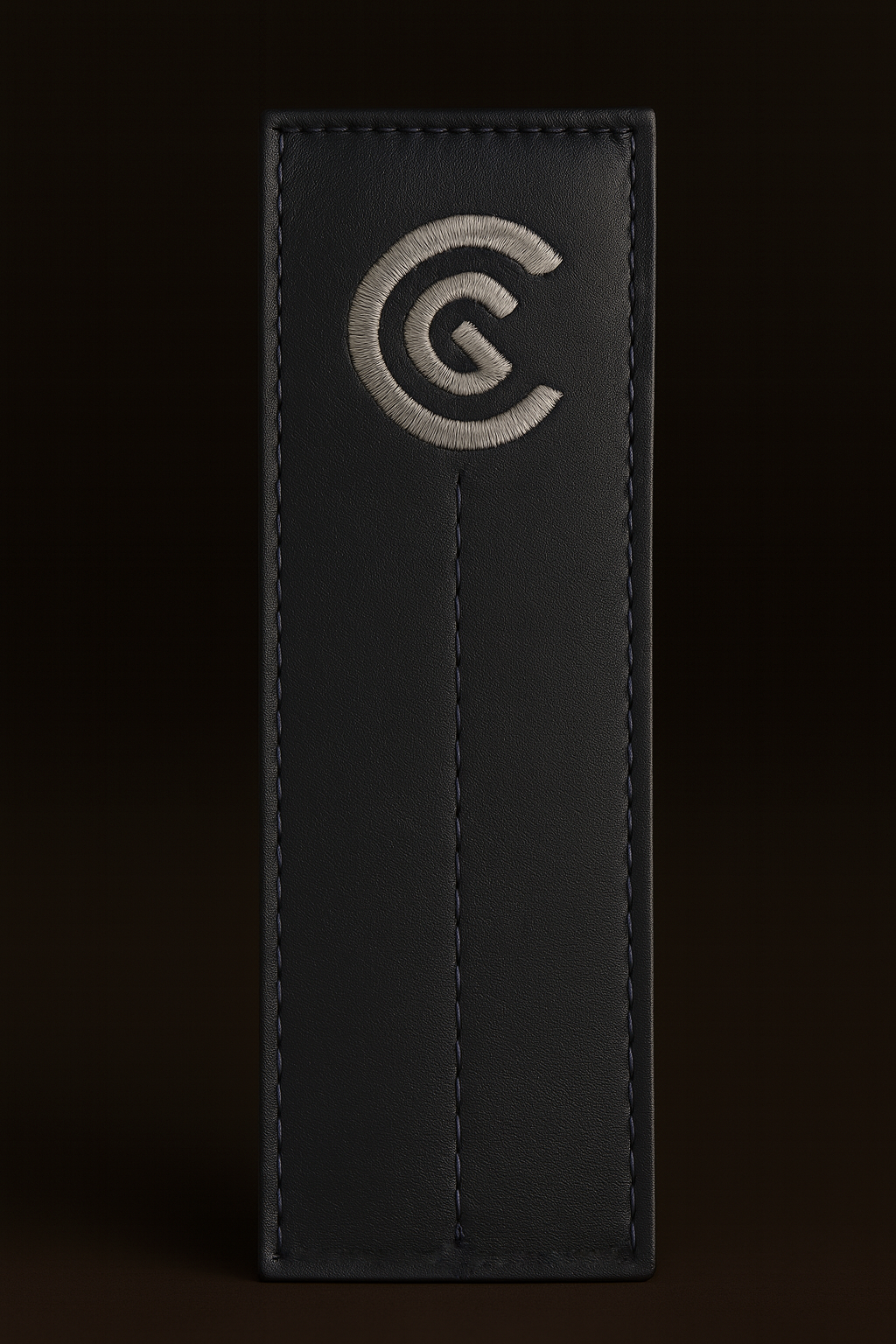 Black leather alignment stick cover with a logo on a black background