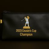 Black pouch with '2023 Cousin's Cup Champion' text and logo on a dark background